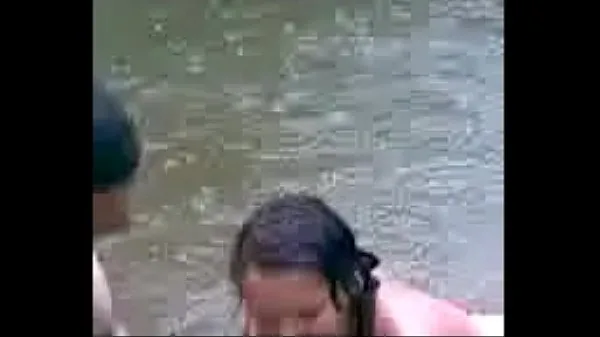 Young girl getting into the river Klip Filmi göster